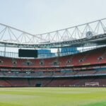 A view of the empty stands and football pitch at Emirates Stadium in London, England.
